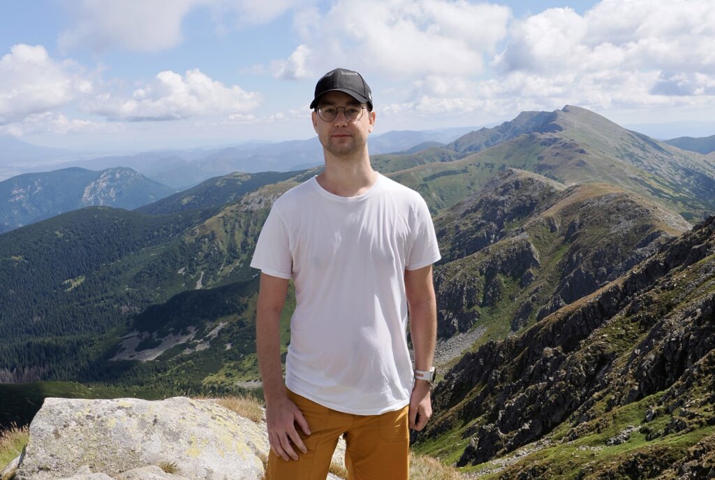 Ivan standing in front of the Slovakian mountains.